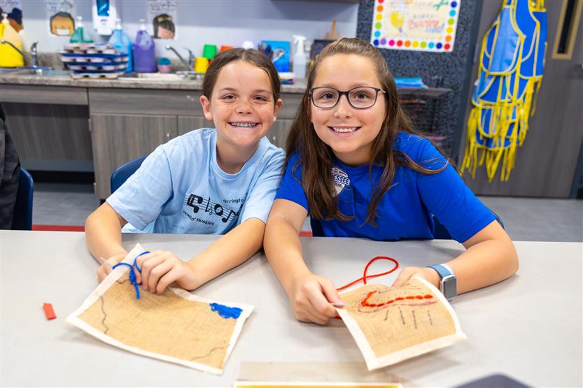 Students learning about embroidery